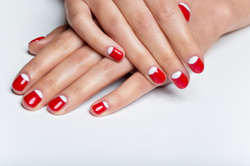 Female hands with red and white nails