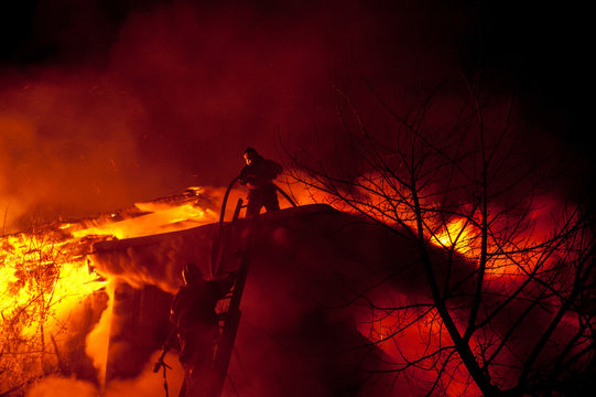 Firefighters extinguish a house