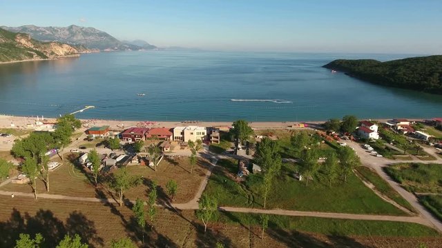Hinterland of the Jaz beach with camping area. Popular beach for sunbathing in Budva municipality. Montenegro. Aerial view
