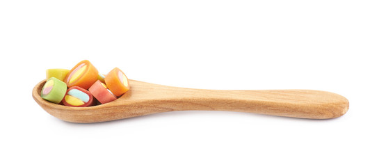 Spoon full of licorice candies isolated