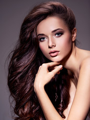 Portrait of the beautiful  young woman with long brown  hair