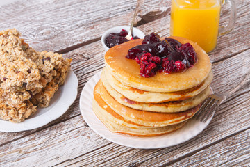 Stack of pancakes with glass of orange juice