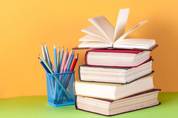 Open book, hardback bookson bright colorful background.