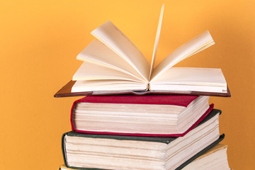 Open book, hardback bookson bright colorful background.