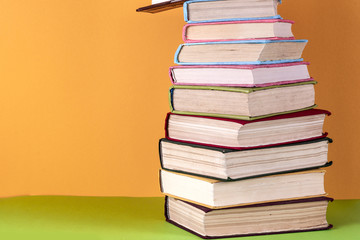 Old books on a wooden shelf. No labels, blank spine.