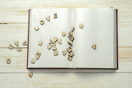 The word love on background of book