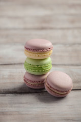 Colorful French macaroons on wooden background, selective focus, copy space