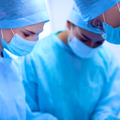 Team surgeon at work in operating room.
