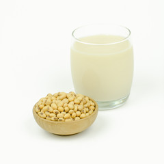 Milk with soy beans on white background.