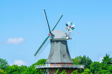 Friesland - Traditional gray windmill with blue sky 