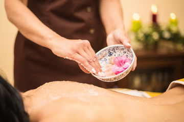 Obraz na płótnie Canvas Rejuvenating massage with petals and salt
