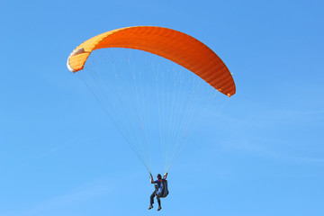 Paraglider in a blue sky