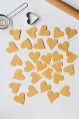 Heart Shaped Biscuits on White Kitchen Table Ready for Baking