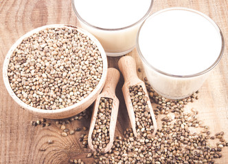 Hemp milk, seeds on wooden background . Close Up .
