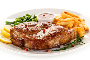 Grilled steak, French fries and vegetables 