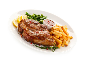 Grilled steak, French fries and vegetables 