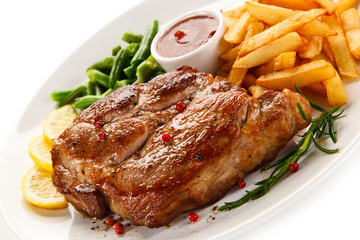 Grilled steak, French fries and vegetables 