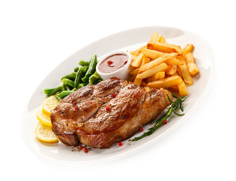 Grilled steak, French fries and vegetables 