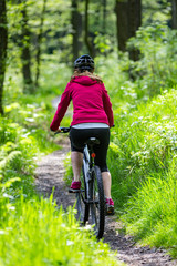 Middle-aged woman riding bicycle