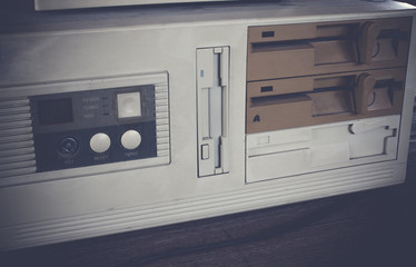 Close-up of ancient old and obsolete personal computer home use on old table wood. Obsolete technology concept.