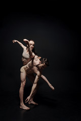 Graceful young gymnasts dancing together in the studio