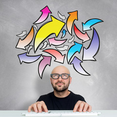 Young attractive smiling geek man with brainstormaing arrow over