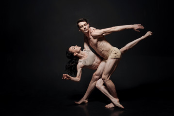 Young involved ballet dancers performing in the studio - obrazy, fototapety, plakaty