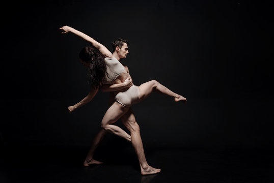 Inventive young dance couple taking part in the art performance