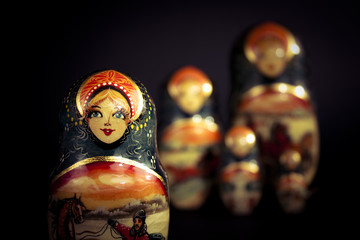 Matryoshka - Pieces of wooden Russian nesting doll isolated on dark background. Still-life picture...