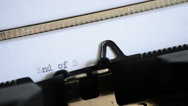 Typing the expression End of Story with an old manual typewriter