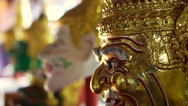 Golden Khon masks performance display in morning sun