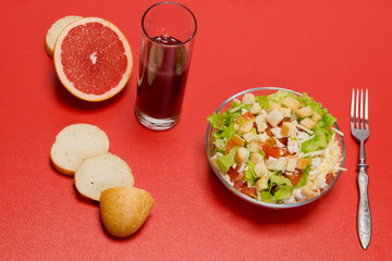 Fresh Caesar salad with grefrutovym juice on the table