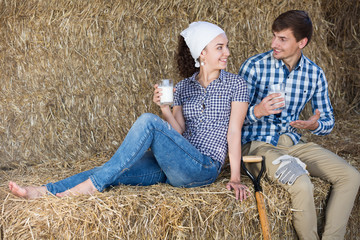 Naklejka na ściany i meble man and woman in hay with milk