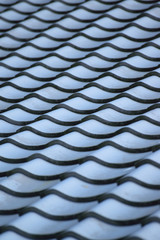 Abstract background tiles on traditional Japanese house roof in vertical frame