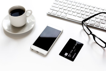 credit card, keyboard, smartphone and coffee cup on white background