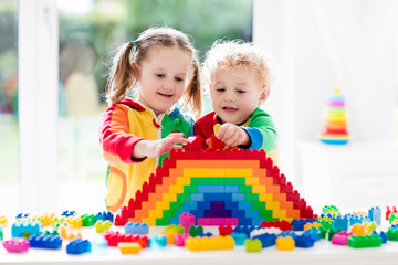 Fototapeta na wymiar Kids playing with colorful blocks