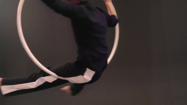 Mujer acr&oacute;bata girando en el aro a&eacute;reo, chica bailarina actuando en el teatro