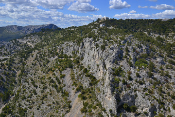 Beautiful mountain landscape with trees, distant buildings and road