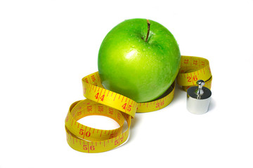 Green apple with measuring tape