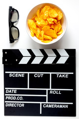 Screenwriter desktop with movie clapper board white background top view