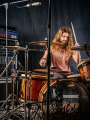 Fototapeta na wymiar Playing the drums in the studio