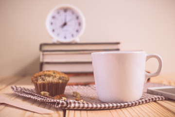 Coffee cup muffin cake and clock on wood table. vintage color ef