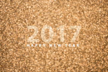 Fototapeta na wymiar Happy new year 2017 on festive gold blur bokeh background