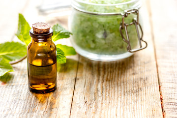 organic cosmetics with herbal extracts of mint on wooden background