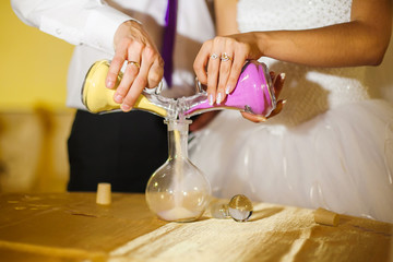 Wedding ceremony of mixing sands in new family