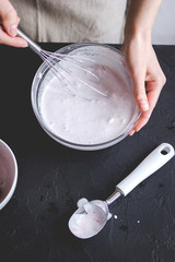 Fototapeta na wymiar organic ice cream homemade process on dark background with hands