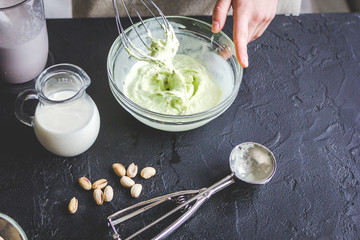 organic ice cream homemade process on dark background with hands