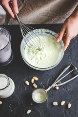organic ice cream homemade process on dark background with hands