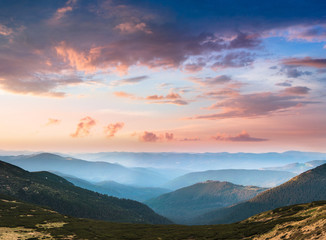 Naklejka na ściany i meble Beautiful landscape in the mountains at sunset. View of colorful sky with clouds.