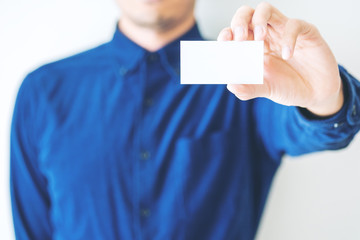 Minimal image of a business man holding and showing empty business card with white background 